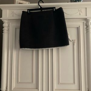 Brand new (no tags) never worn gray flannel/wool mini skirt with white piping.